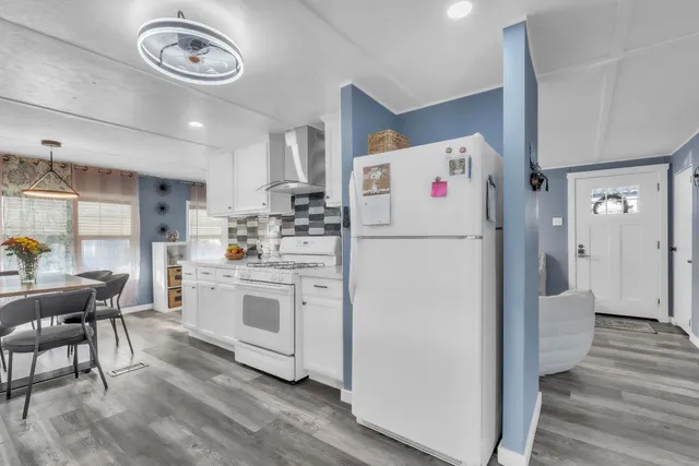 a white refrigerator freezer sitting inside of a kitchen