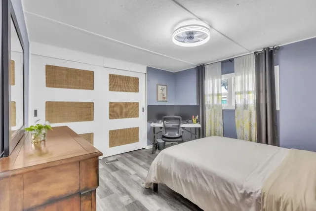 a bedroom with a bed dresser and a window