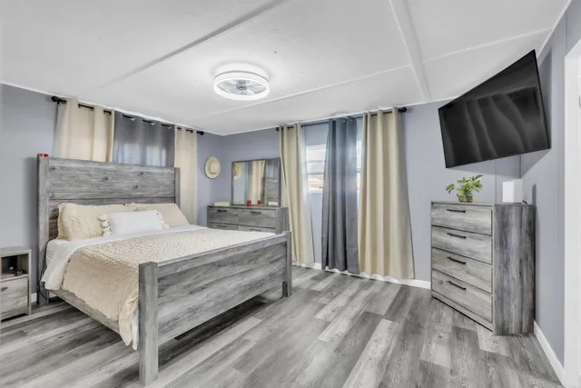 a bedroom with a bed closet and flat tv screen