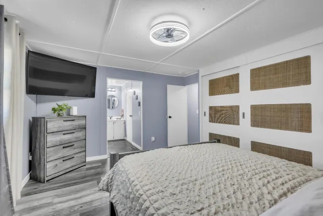 a bedroom with a bed and a flat screen tv