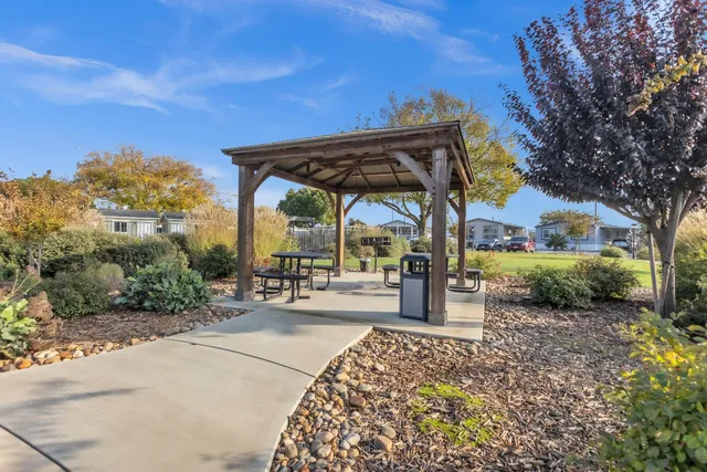 a view of a porch with a table and chairs under an umbrella