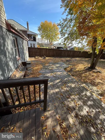 a view of a yard with large trees