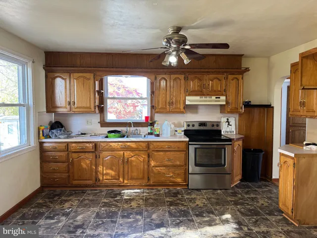 a kitchen with a stove a sink and a refrigerator
