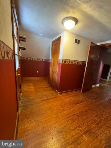wooden floor in an empty room with a mirror