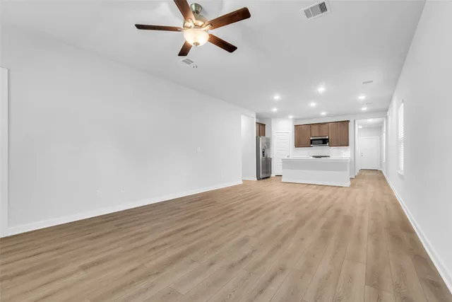 a view of a kitchen with a sink and a refrigerator