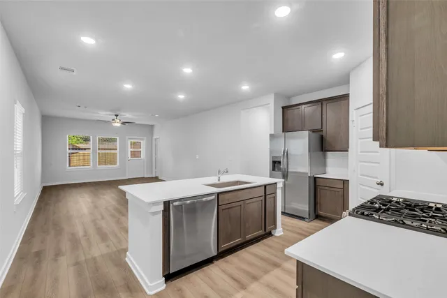 a kitchen that has a sink and a stove in it