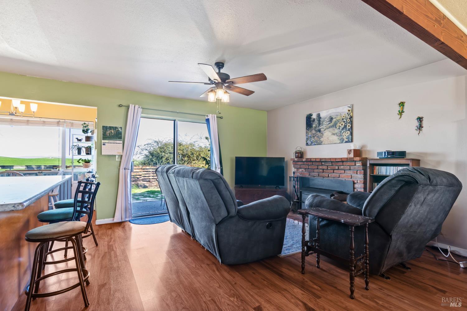 17 Amador Circle Rio Vista, CA 94571 - Photo 11 of 42 a living room with furniture a flat screen tv and a large window