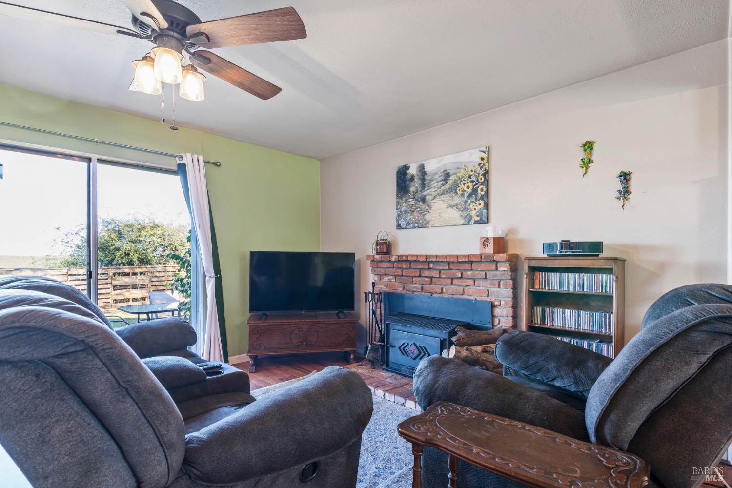 17 Amador Circle Rio Vista, CA 94571 - Photo 12 of 42 a living room with furniture a window and a flat screen tv