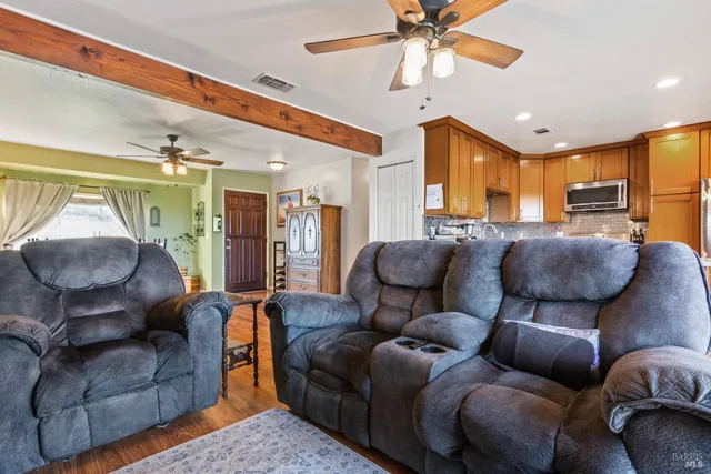 a living room with furniture and a chandelier