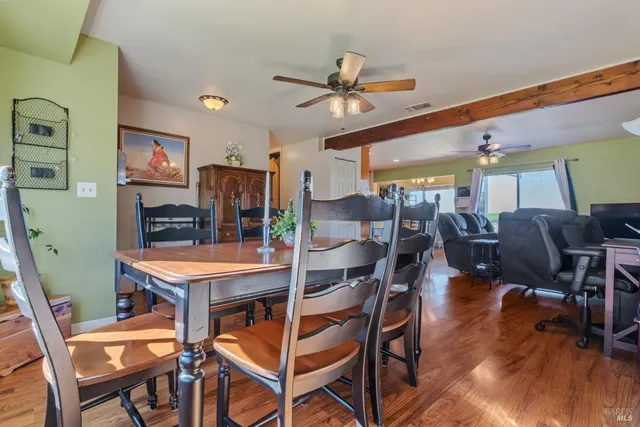a view of a dining room with furniture and wooden floor