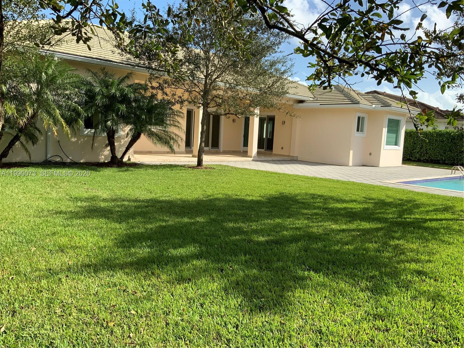 12308 Southwest 94th Place Miami, FL 33176 - Photo 15 of 21 a front view of a house with a yard and trees