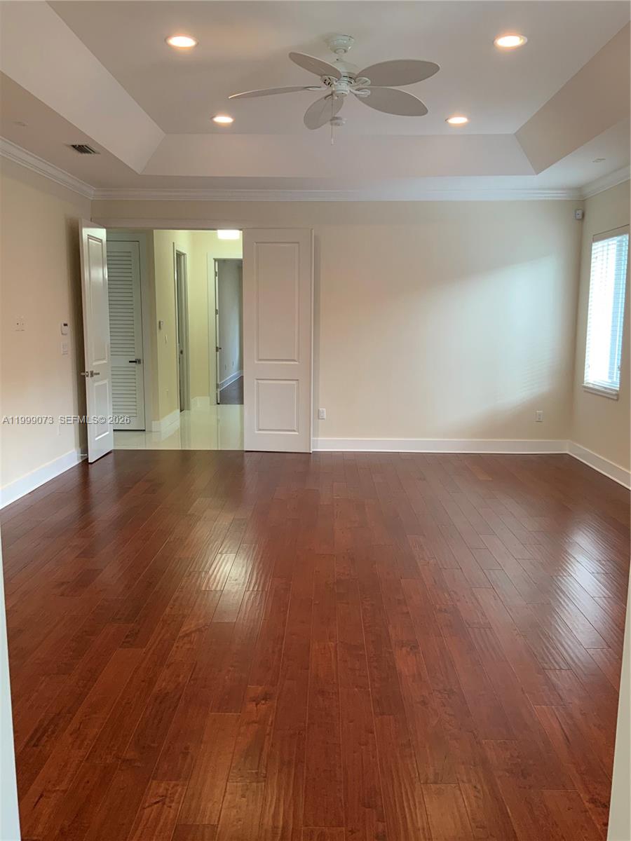 12308 Southwest 94th Place Miami, FL 33176 - Photo 16 of 21 an empty room with wooden floor and windows
