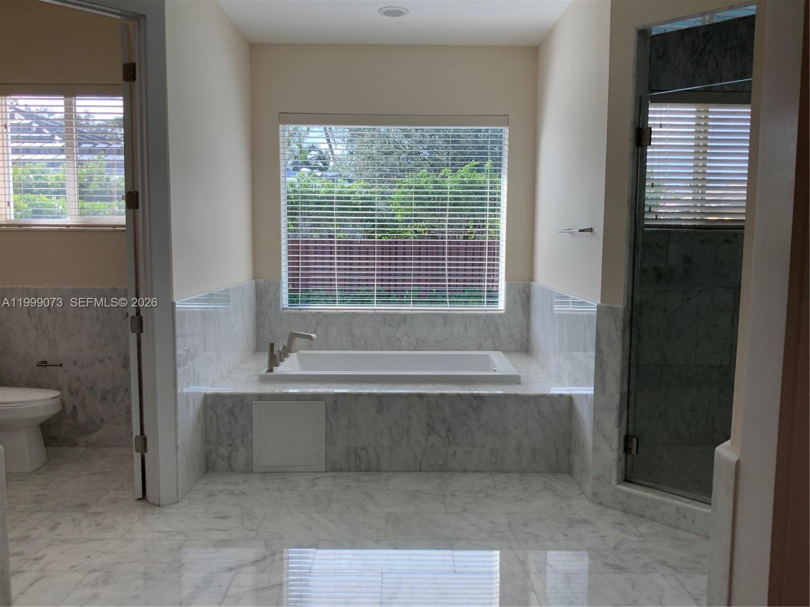 12308 Southwest 94th Place Miami, FL 33176 - Photo 17 of 21 a spacious bathroom with a bathtub and a toilet