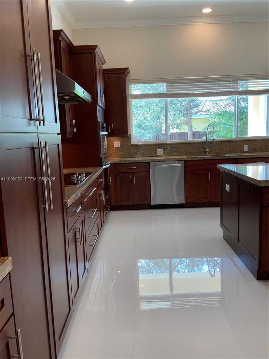 12308 Southwest 94th Place Miami, FL 33176 - Photo 19 of 21 a kitchen with stainless steel appliances granite countertop a refrigerator a sink a stove and a refrigerator