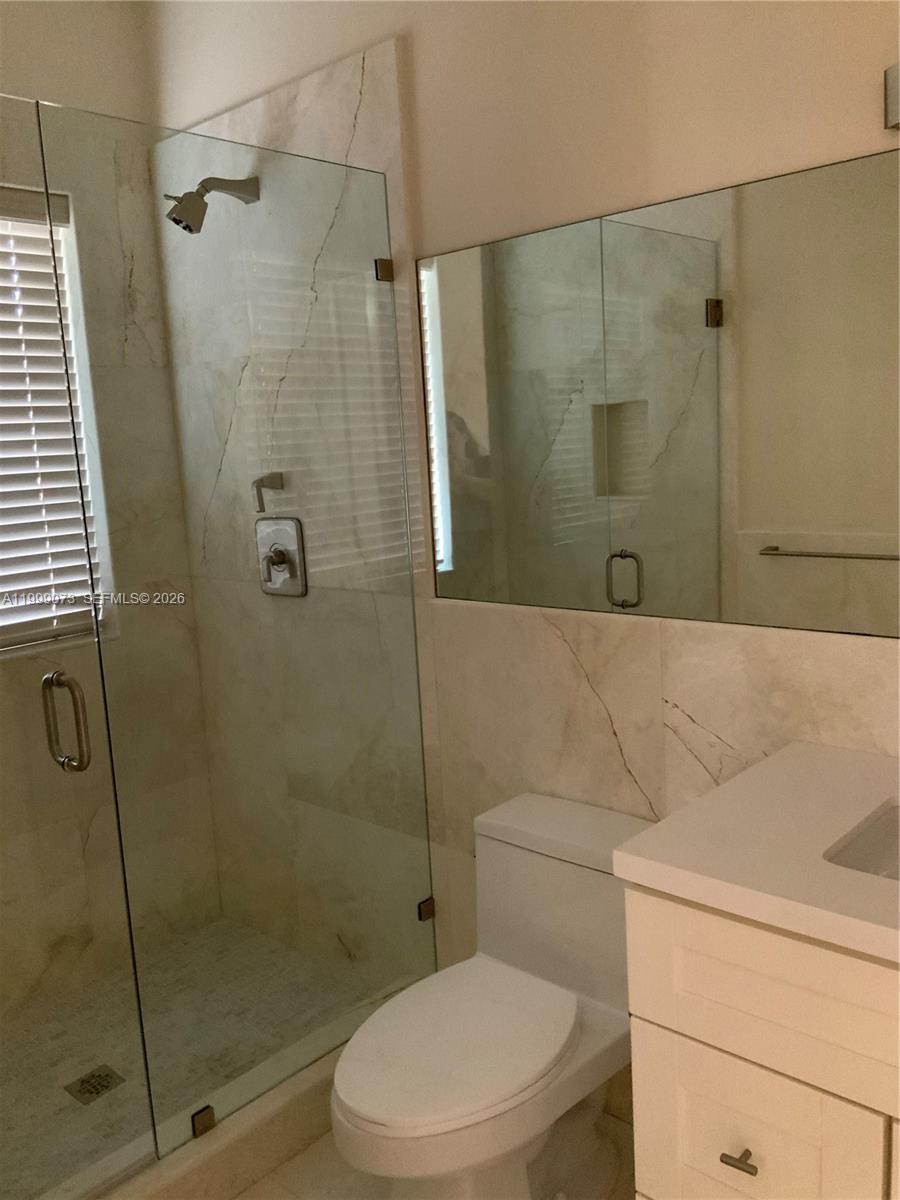 12308 Southwest 94th Place Miami, FL 33176 - Photo 20 of 21 a bathroom with a toilet and shower