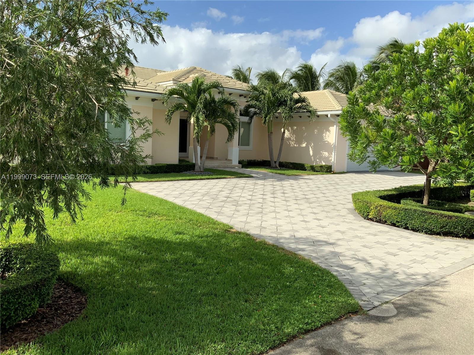 12308 Southwest 94th Place Miami, FL 33176 - Photo 2 of 21 a front view of a house with a yard