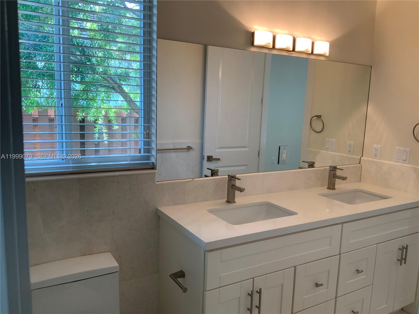 12308 Southwest 94th Place Miami, FL 33176 - Photo 21 of 21 a bathroom with a sink and a mirror