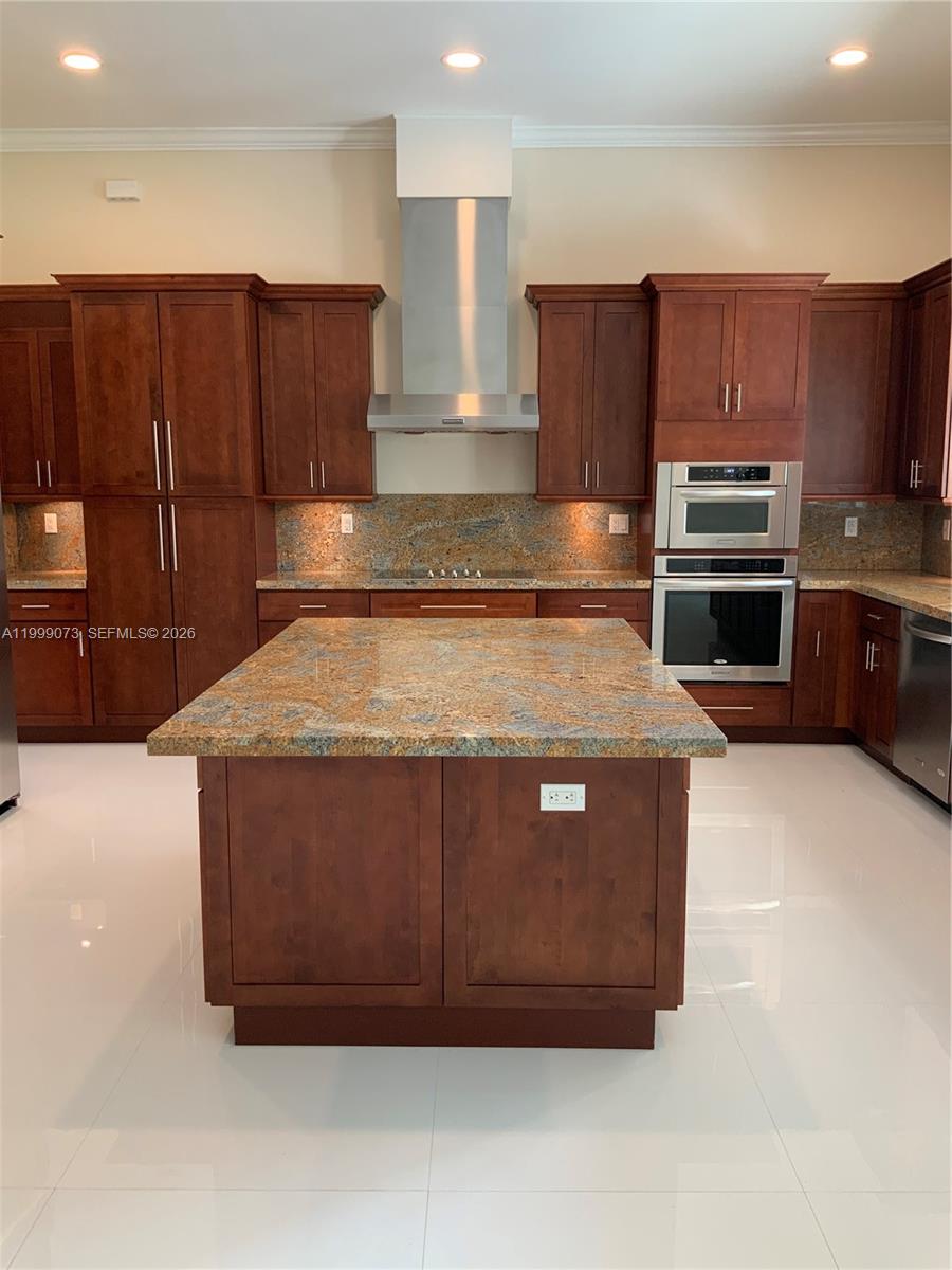 12308 Southwest 94th Place Miami, FL 33176 - Photo 9 of 21 a kitchen with wooden cabinets