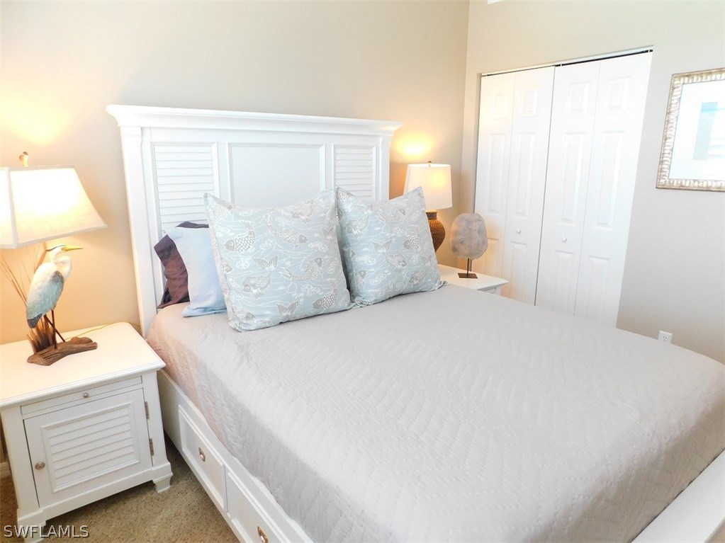 2090 Matecumbe Key Road, Unit 1307 Punta Gorda, FL 33955 - Photo 12 of 25 a bedroom with a bed and a dresser