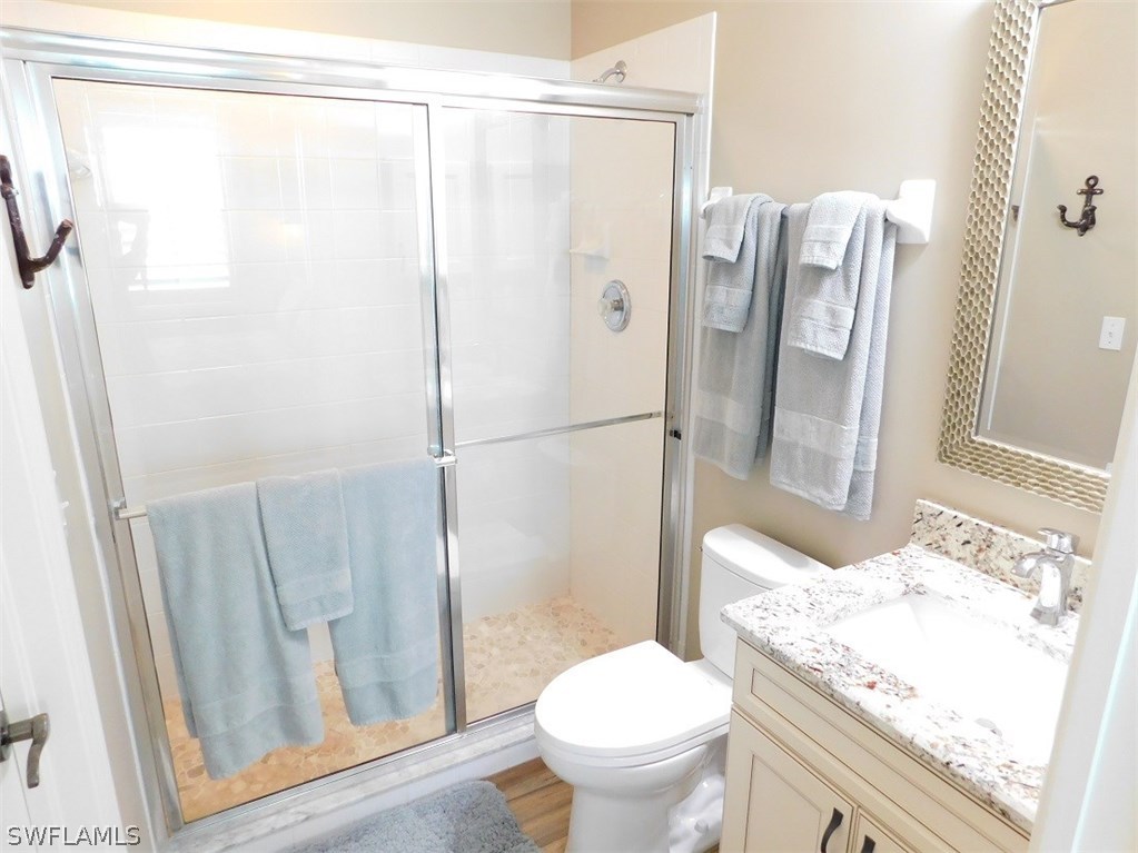 2090 Matecumbe Key Road, Unit 1307 Punta Gorda, FL 33955 - Photo 19 of 25 a bathroom with a granite countertop sink toilet and shower