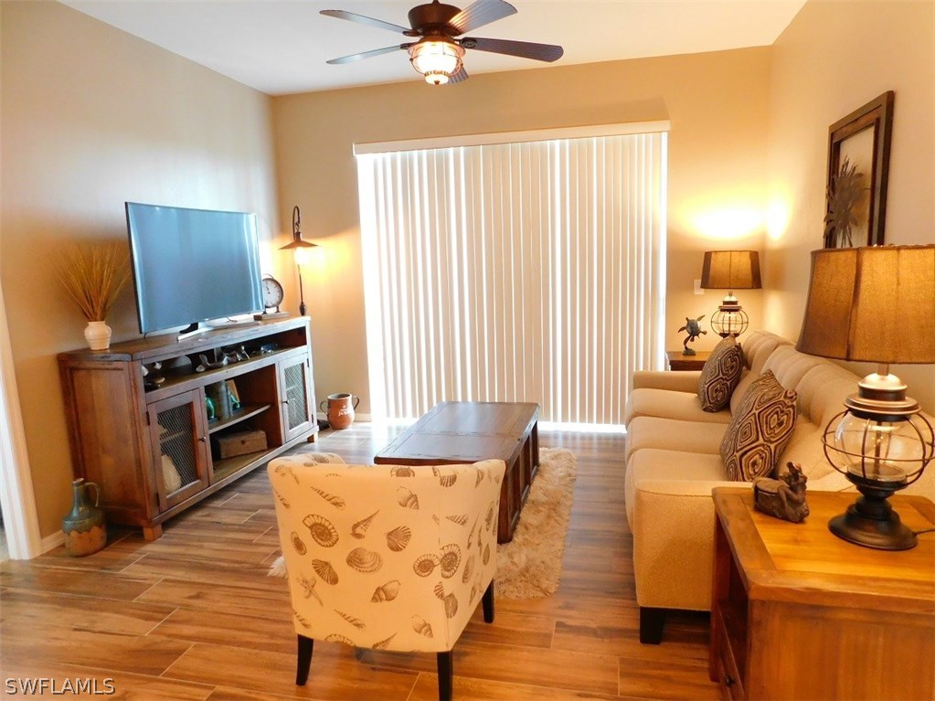 2090 Matecumbe Key Road, Unit 1307 Punta Gorda, FL 33955 - Photo 9 of 25 a living room with furniture and a fireplace