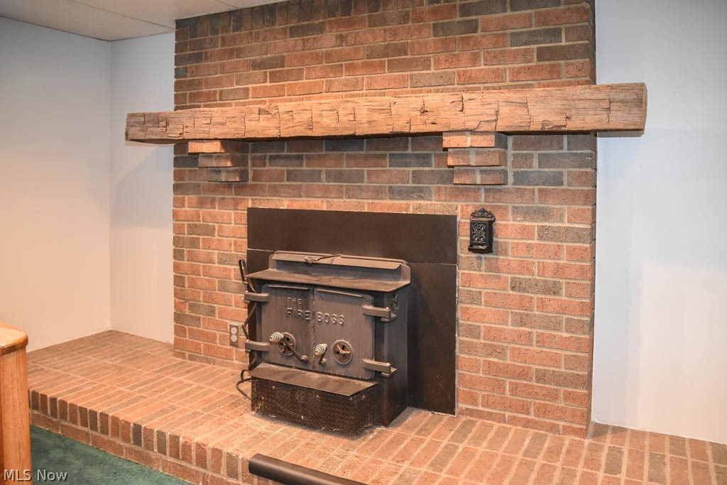 1629 Ferndale Road Northwest Canton, OH 44709 - Photo 25 of 35 Rec room fireplace with a barn beam mantle.