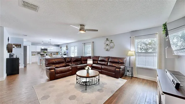 a living room with furniture and wooden floor