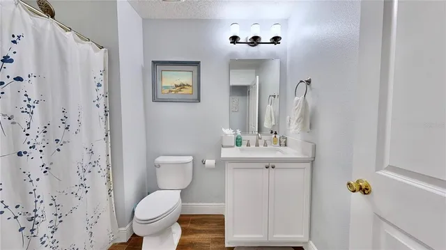 a white toilet sitting next to a bathroom sink