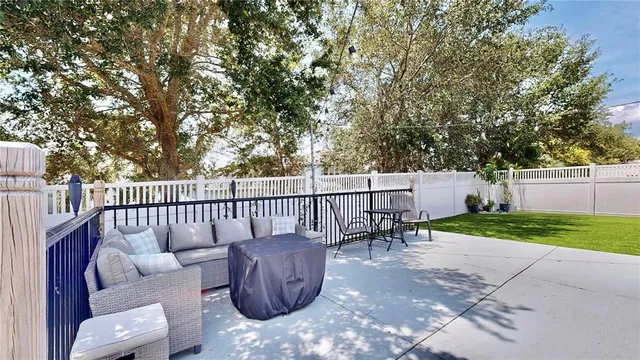 a view of a patio with couches and a couple of chairs