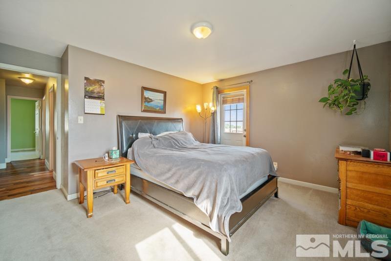 5100 Amy Road Reno, NV 89510 - Photo 13 of 35 a bedroom with a bed and a lamp on table