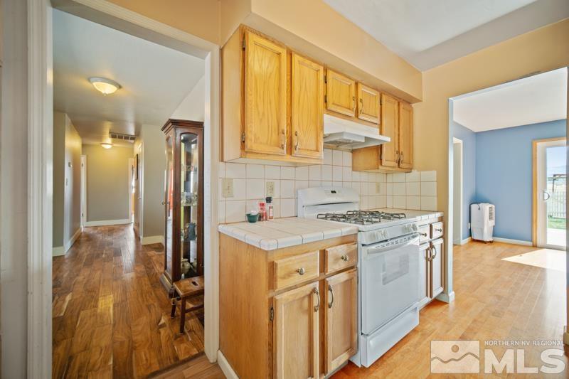 5100 Amy Road Reno, NV 89510 - Photo 8 of 35 a kitchen with a stove a sink and a refrigerator