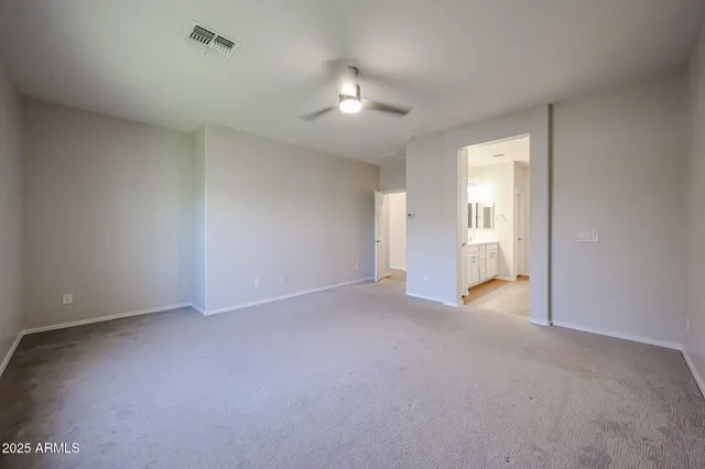 a view of an empty room with a ceiling fan