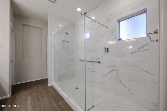 a bathroom with a shower and a tub