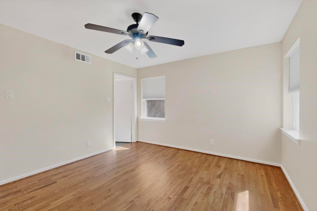 2120 Healey Drive Dallas, TX 75228 - Photo 27 of 39 a view of a big room with wooden floor closet ceiling fan and wooden floor