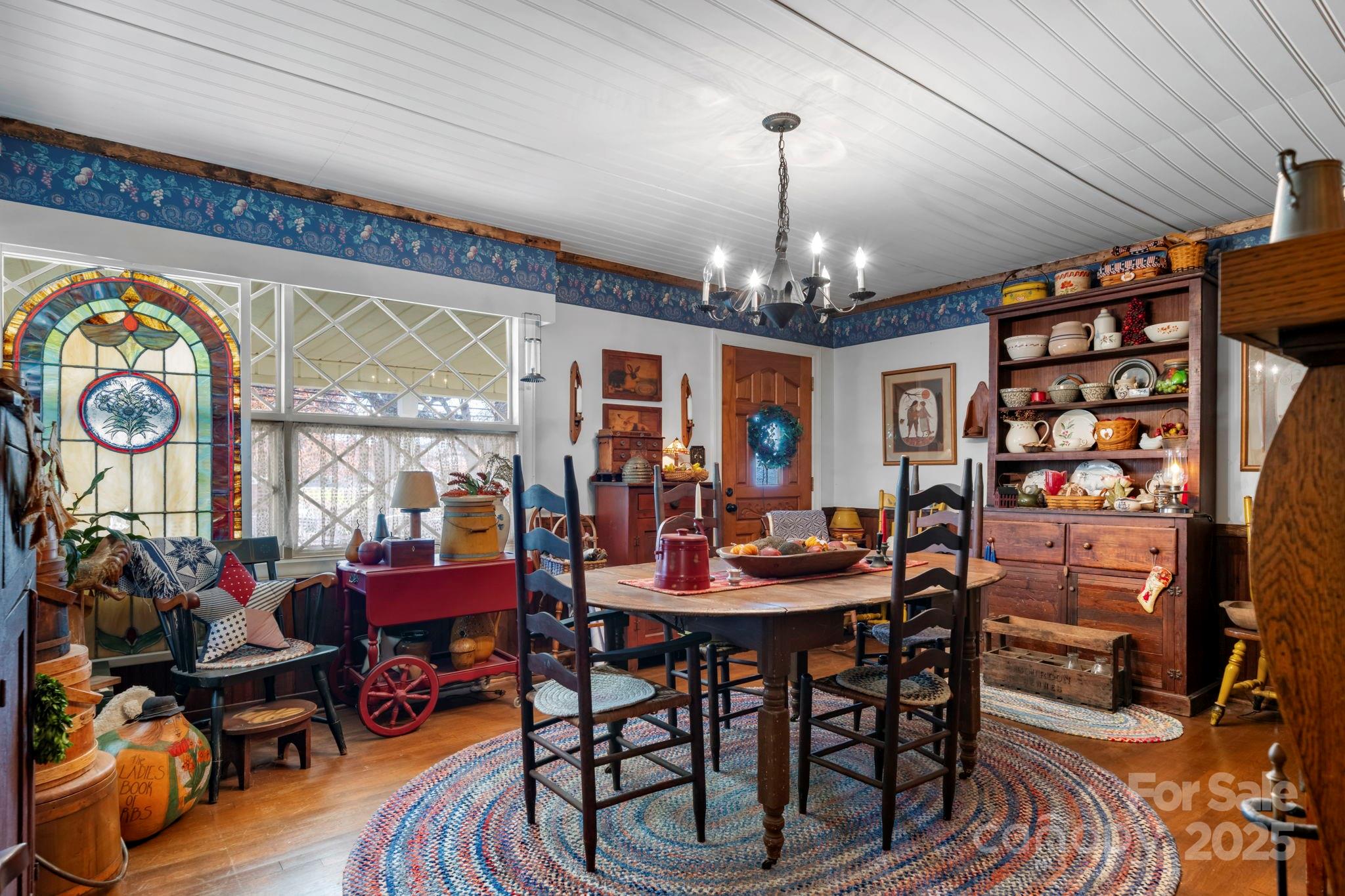 901 Union Street Maiden, NC 28650 - Photo 15 of 37 a view of a dining room with furniture a chandelier and wooden floor