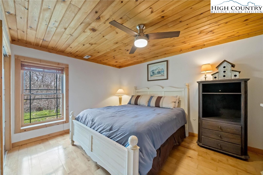 140 Spruce Hollow Road Beech Mountain, NC 28604 - Photo 29 of 50 a spacious bedroom with a bed and a view of bedroom