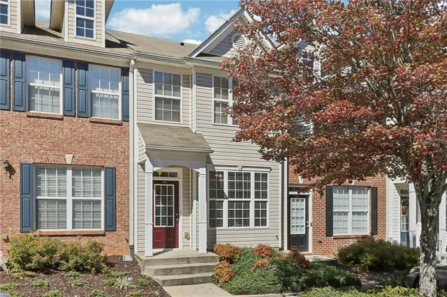 front view of a brick house with a large windows