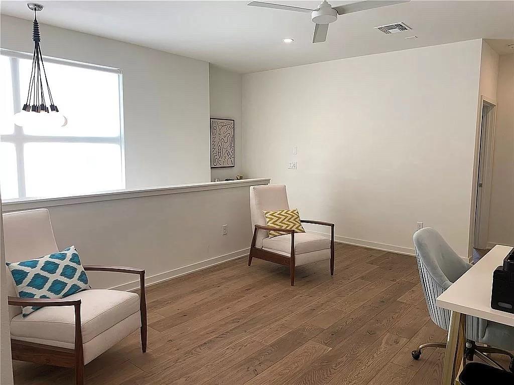 2519 Sutherland Street Austin, TX 78746 - Photo 10 of 14 a living room with furniture and a wooden floor