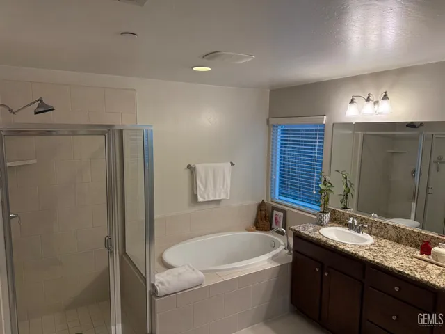 a bathroom with a double vanity sink and mirror