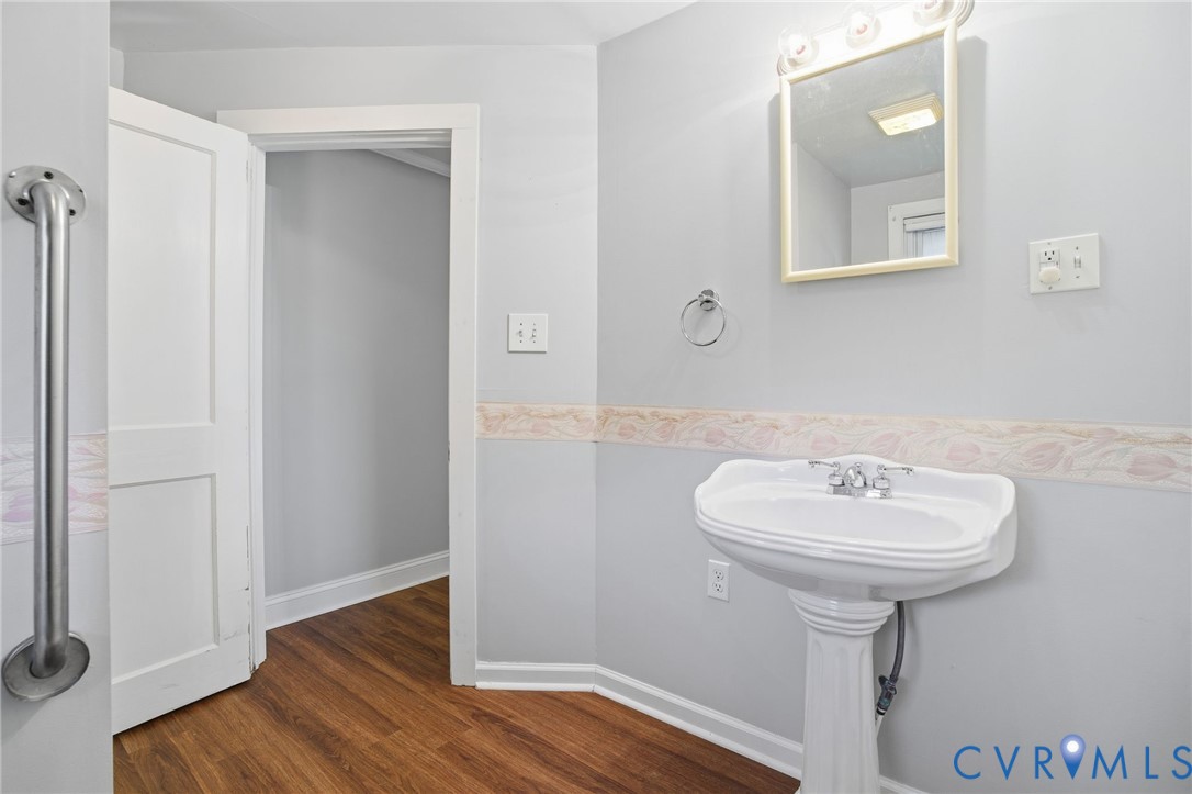 9102 Boydton Plank Road Petersburg, VA 23803 - Photo 15 of 32 a bathroom with a sink a mirror and a shower