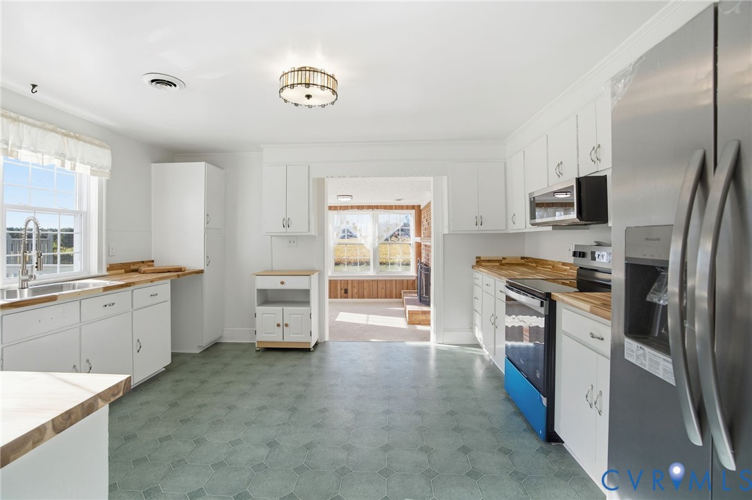 9102 Boydton Plank Road Petersburg, VA 23803 - Photo 3 of 32 a kitchen with stainless steel appliances a refrigerator sink and stove