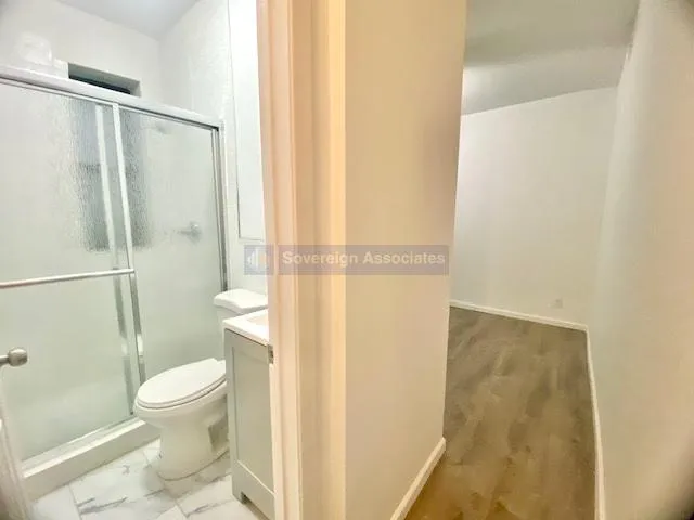 a view of a room with cabinet and a ceiling fan