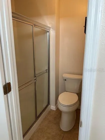 a white toilet sitting next to a sink