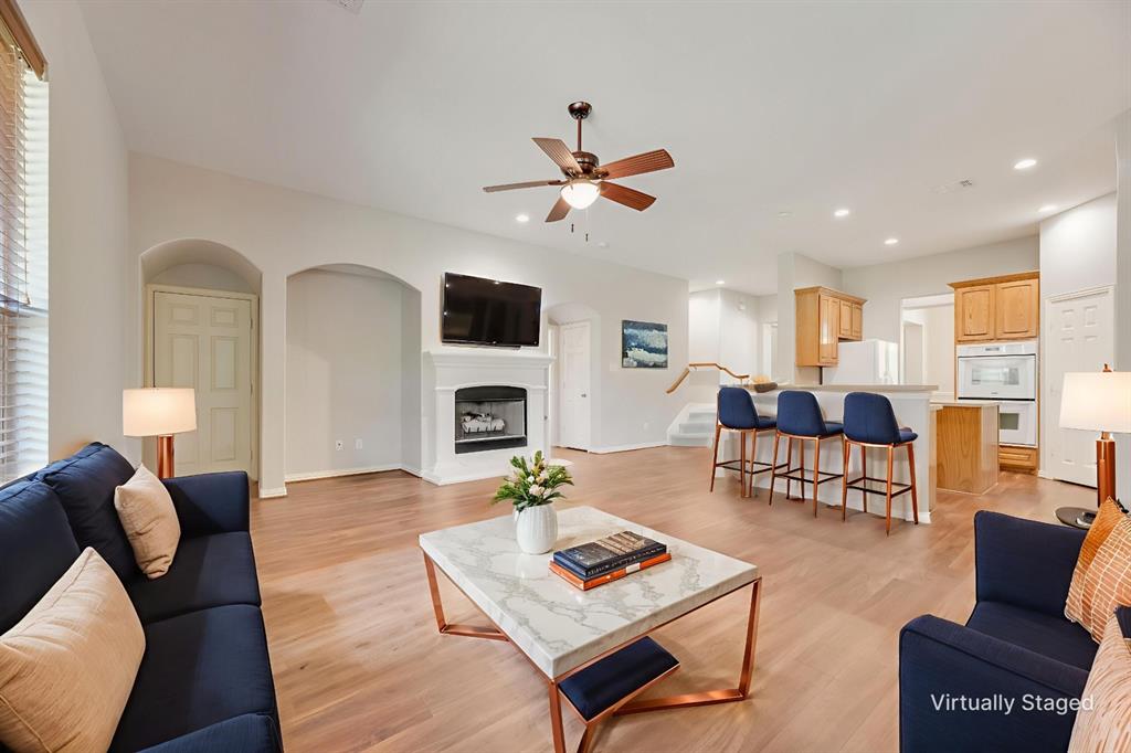 a living room with furniture fireplace and a table