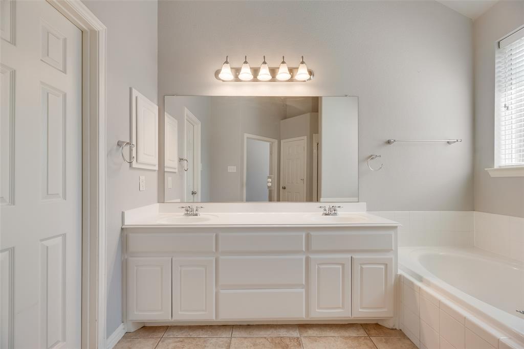 1522 Farm Dale Allen, TX 75002 - Photo 23 of 40 a bath room with a sink and a mirror