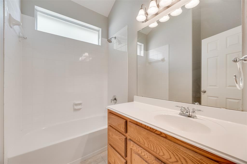 1522 Farm Dale Allen, TX 75002 - Photo 29 of 40 a bathroom with a bathtub and a sink