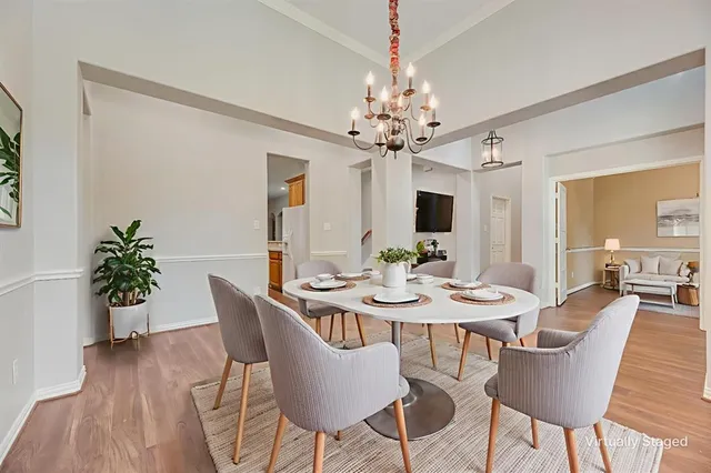 a view of a dining room with furniture wooden floor and chandelier