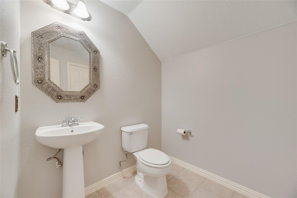 1522 Farm Dale Allen, TX 75002 - Photo 31 of 40 a bathroom with a toilet sink and mirror
