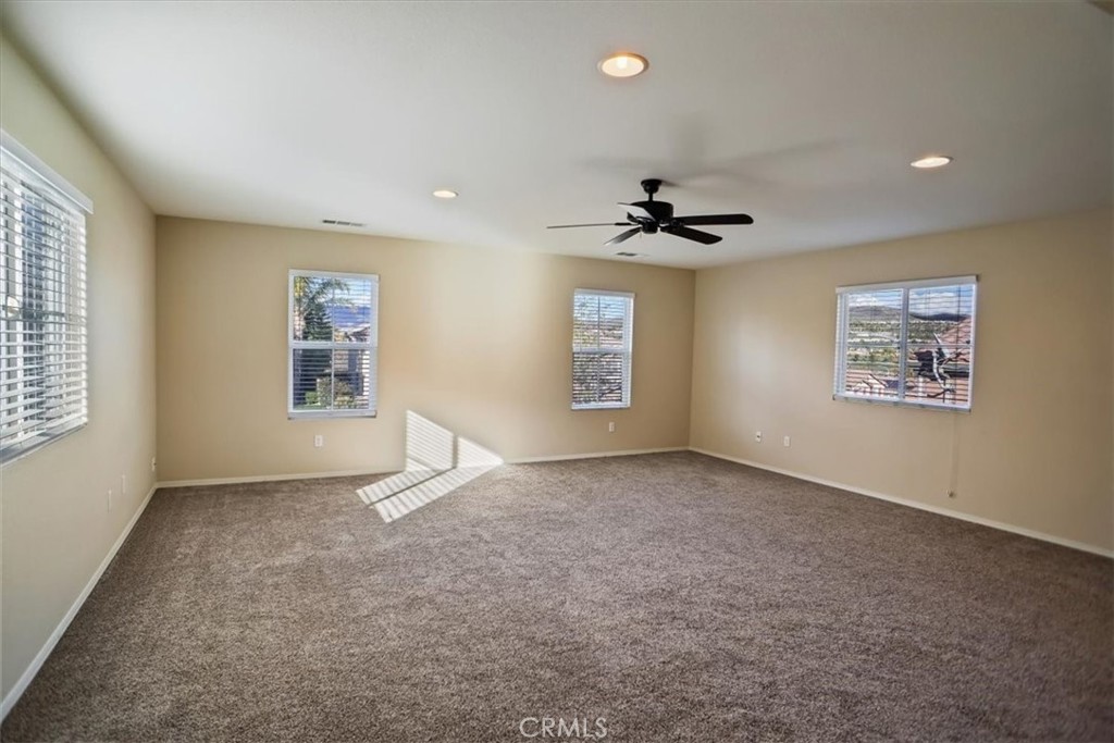 20046 Christopher Lane Saugus, CA 91350 - Photo 13 of 25 an empty room with windows and ceiling fan