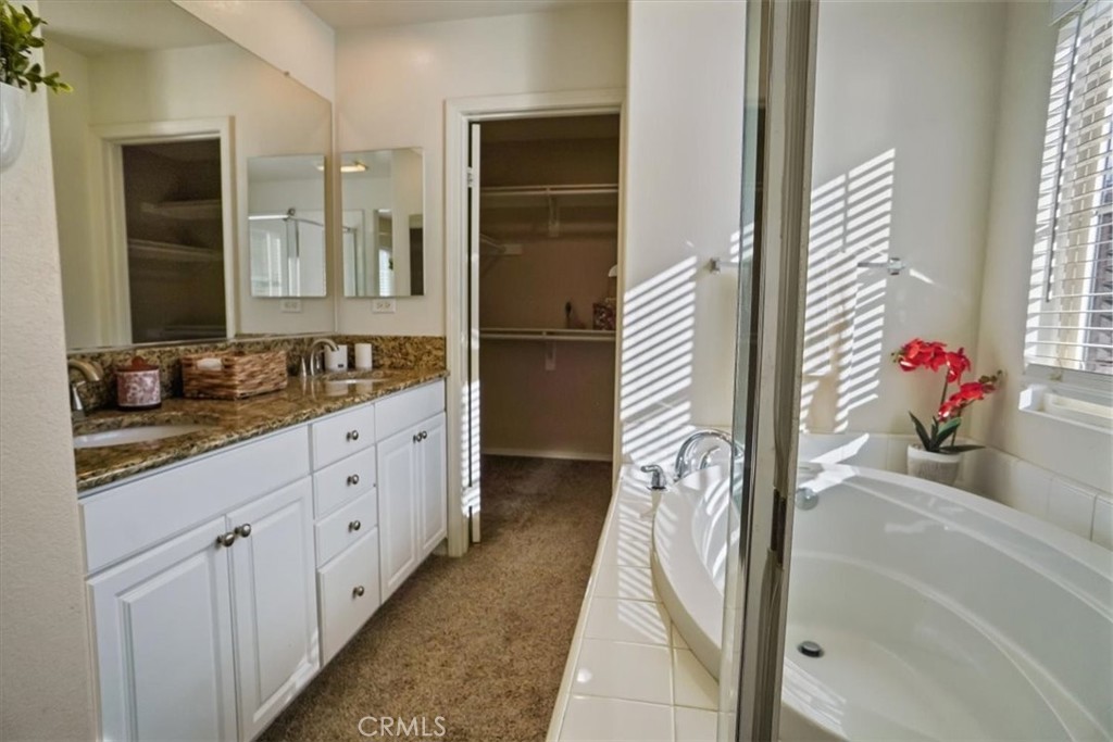 20046 Christopher Lane Saugus, CA 91350 - Photo 17 of 25 a bathroom with a tub sink and mirror